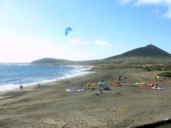 Kitesurfing on El Médano beach with Montaña Roja in the background