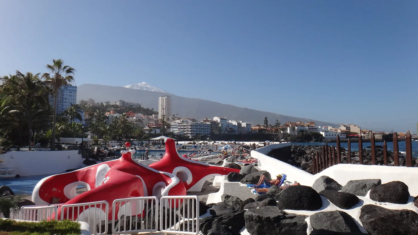 La Jibia, el pulpo rojo y blanco de la piscina infantil del Lago Martiánez, con el Teide nevado al fondo